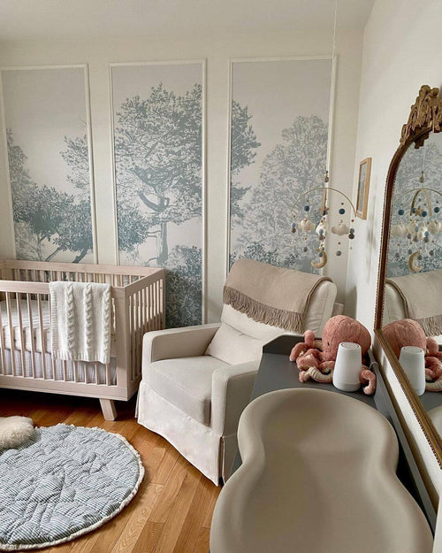 Hua Trees Blue Mural Wallpaper behind table and chair Sian Zeng