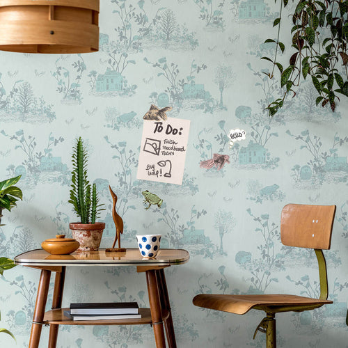 light blue enchanted forest magnetic wallpaper used as noticeboard in home office with magnets holding up note