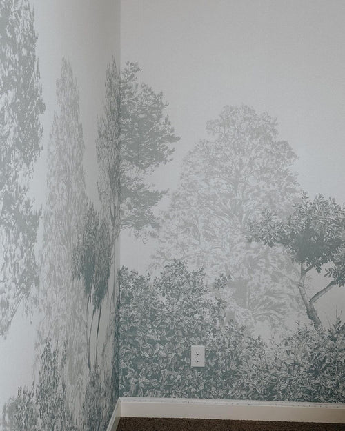 Hua Trees Blue Mural Wallpaper behind table and chair Sian Zeng