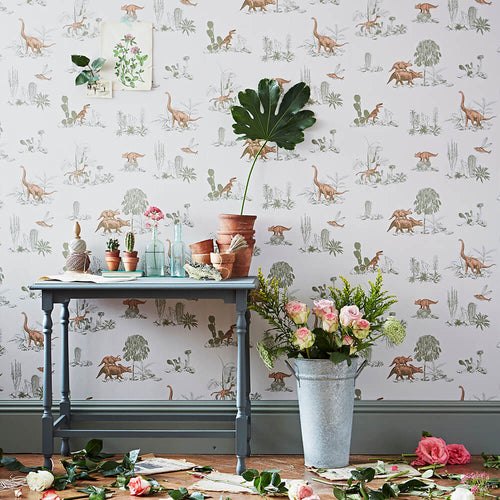 Dinosaur wallpaper styled with flowers and grey vintage table