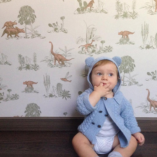 Dinosaur wallpaper styled with flowers and grey vintage table