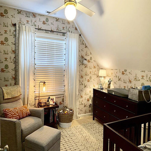 Dinosaur wallpaper styled with flowers and grey vintage table