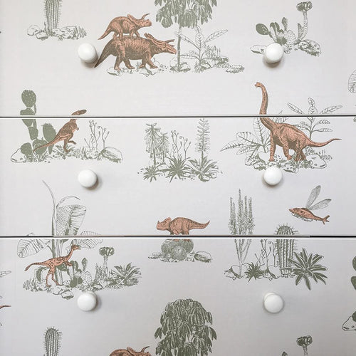 Dinosaur wallpaper styled with flowers and grey vintage table